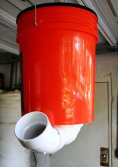 a large red bucket hanging from the ceiling