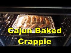 an oven filled with baked cranberries in it's baking pan and the words cajun baked crapie