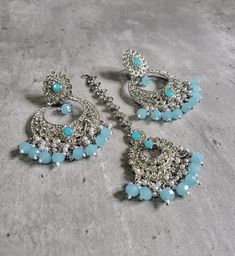 We are thrilled to introduce our exquisite collection of Indian earrings in Silver and Mint blue color. These stunning earrings are crafted to enhance your style, whether you're attending a party or a wedding ceremony. They are guaranteed to make you stand out in the crowd.Elevate your style with these stunning Earrings. Make a bold fashion statement and turn heads wherever you go. Shop our stunning collection today!We have a wide range of colors available, so be sure to check our other listings Blue Dangle Danglers For Wedding, Turquoise Kundan Earrings For Wedding, Blue Festive Jhumkas Drop Earrings, Blue Jhumkas Drop Earrings For Festive Occasions, Blue Bollywood Jewelry Sets For Gift, Blue Bollywood Style Jewelry Sets For Gift, Blue Drop Danglers For Festive Occasions, Blue Danglers For Party, Festive Blue Danglers For Gift