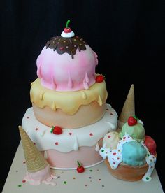 a three tiered cake with ice cream and toppings