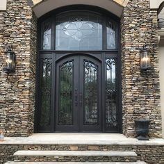 the front entrance to a home with stone steps and glass doors that lead into it