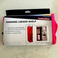 the hanging locker shelf is pink and has two shelves on each side that hold books