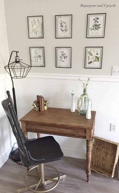 a chair and desk in a room with pictures on the wall above it, along with other items