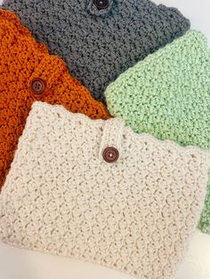 four crocheted purses sitting on top of each other