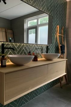 a bathroom with two sinks and a large mirror above the sink in front of it