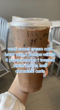 a person holding up a cup with whipped cream in it and the caption reads, venti sweet cream cold brew with 2 pumps vanilla 4 pumpkin toasted white