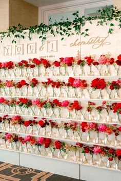 flowers are arranged in vases on the wall