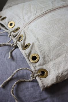 a close up of a pillow with buttons on it