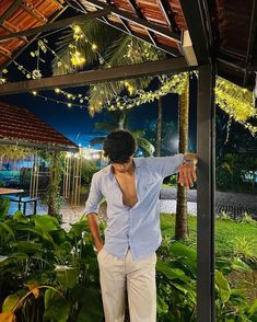 a man standing in front of a gazebo at night