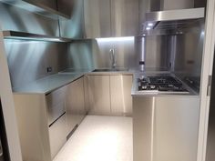 an empty kitchen with stainless steel appliances and cabinets