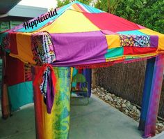 a multicolored tent sitting on top of a sidewalk