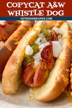 two hotdogs with condiments sitting on a plate