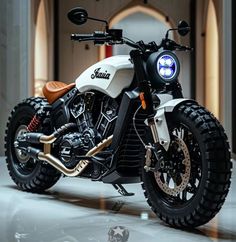 a white and black motorcycle parked in front of a building