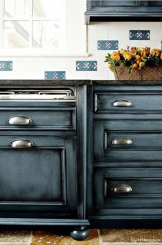 an old fashioned kitchen with blue painted cabinets