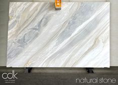 a white marble counter top with an orange bottle on it