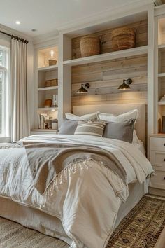 a large bed sitting in a bedroom next to a window with lots of shelves above it