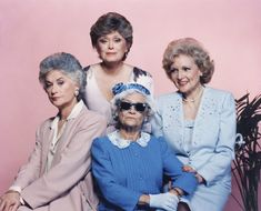 an old photo of three women sitting next to each other in front of a pink background