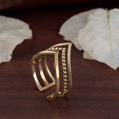 "Triple chevron ring, crown ring, boho ring, wishbone ring, gift for her, gift for mom, curve band, thumb ring, triple v ring, knuckle ring.   ❥ A chevron is an inverted V-shaped pattern. The word is usually used in reference to a kind of fret in architecture, or to a badge or insignia used in military or police uniforms to indicate rank or length of service, or in heraldry and the designs of flags.  ❥ The brass metal will develop a nice antique color over time. So, I suggest cleaning it once in a while to get back to the shiny original color. You can use natural ingredients like lemon or vinegar with water to clean it. Also, apply a thin coat of transparent nail paint/enamel on the ring's inner side to save it from tarnishing. All our products are Nickel and Lead-free & tarnish-resistant. V Ring Design, V Shape Ring Gold, V Shaped Ring, Rudraksha Bracelet, Ring Crown, V Ring, Wishbone Ring, Gold Jewellry, Brass Collection