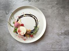 a white plate topped with different types of desserts on top of a gray table