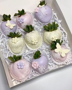 a box filled with chocolate covered strawberries on top of a white lace table cloth