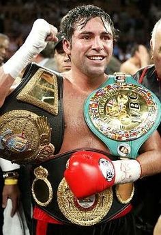 a man standing next to another man wearing boxing gloves