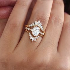 a woman's hand with a diamond ring on top of her finger and an engagement band