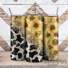 three sunflowers with black spots and gold glitter on them are shown in front of a wooden wall