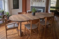 a dining room table with four chairs and a potted plant on the top of it