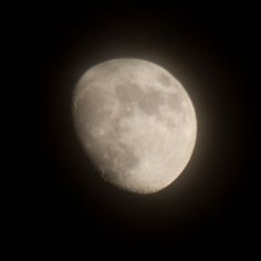 the full moon is visible in the dark sky