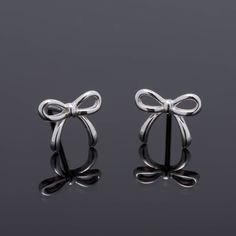 Pair of stud Earrings of delicate design in the form of a bow, made in Real 925 silver in a minimalist style, ideal gift for girl, teenager or woman. Material: 100% 925 Sterling Silver. Bolt size: 6mm x 10mm. Weight: 0.66 grams per pair. Tips for the care of your Silver Jewelry: * Keep your silver jewelry in a cool and dry place to avoid oxidation. * Avoid exposing them to water, perfume, and harsh chemicals. * Clean your Silver jewelry relatively frequently to maintain its shine and beauty. All Silver Earrings Aesthetic, Small Silver Earrings, Ribbon Earrings, Gift Bow, Water Perfume, Ear Jacket Earring, Dainty Studs, Silver Bow, Small Earrings Studs