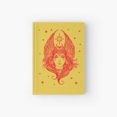 a yellow book with an image of a woman's face and wings on it