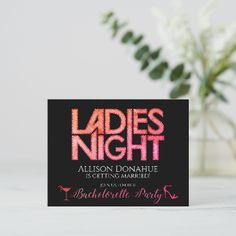 a card with the words ladies night written on it next to a vase filled with flowers