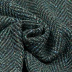 a close up view of a green and blue tweed fabric