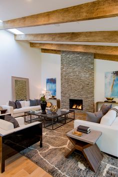 Stacked slate fireplace, wooden beam ceiling, artworks & comfy couches in warmly textured modern luxury Beverly Hills living room. Wooden Beam Ceiling, Slate Fireplace, Beverly Hills, Architects, Fireplace