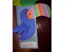 a blue bird with a colorful striped beak on it's head and the words i have to touch looking at me