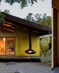 a yellow house with a fire place in the middle