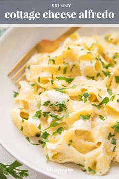 a white plate topped with pasta covered in cheese