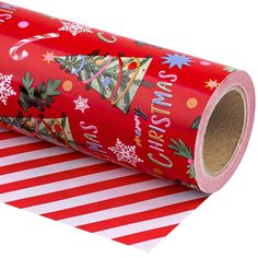 a roll of christmas wrapping paper on top of a red and white striped table cloth