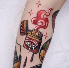 a person with a tattoo on their leg has a hot dog and ketchup