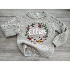 a gray sweater with flowers and the word ellen written in white on it's chest