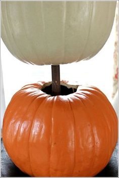 an orange pumpkin sitting on top of a black table