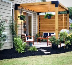 an outdoor patio with chairs and plants on the ground next to a wooden pergoline