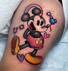 a cartoon mickey mouse tattoo on the right thigh, with hearts and rainbows around it