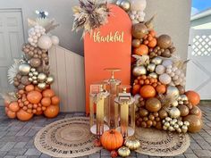 an assortment of orange and gold decorations in front of a sign that says hakkah