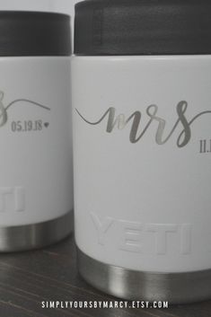 two personalized yeti jars sitting next to each other on top of a table