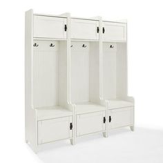 three white wooden lockers sitting next to each other on top of a white floor