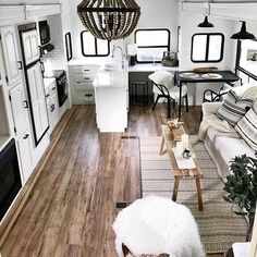 the interior of a mobile home with wood flooring