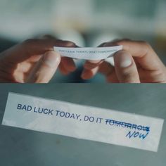 a person holding a piece of paper that says bad luck today, do it tomorrow