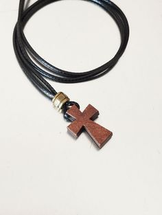 Mens necklace with carved wooden cross pendant on wax cotton cord and decorative bronze metal bead, lobster clasp closure. Brown wood cross rope necklace, religious jewelry for men. A great gift for him. Wooden cross pendant: 20 x 13 mm Metal bead: 6 mm For all products are used only genuine high-quality Italian leather, natural stones and wood. All metal materials are lead and nickel free.  /Gift wrapping and packaging/ :   All items ordered will be placed in a gift bag and shipped in a bubble mailer. /Jewelry care instructions/: Not recommended bathing, physical activity, swimming, sleeping while wearing jewelry. It may damage all the components of the product. Mens Cross Necklace, Leather Bangle, Hematite Necklace, Leather Wristbands, Stone Beaded Necklace, Rope Necklace, Agate Necklace, Men's Necklace, Cross Jewelry