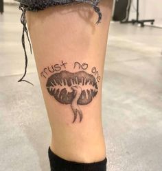 a person with a tattoo on their leg that says, must not be dead in black ink